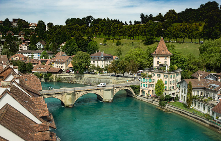 Idyllic Alpine village with a medieval bridge crossing the river